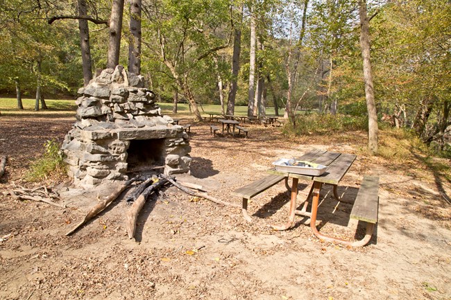 Picnic Table and Historic Stone Grill at Picnic Area 07 A picnic table sits beside a stone chimney grill.